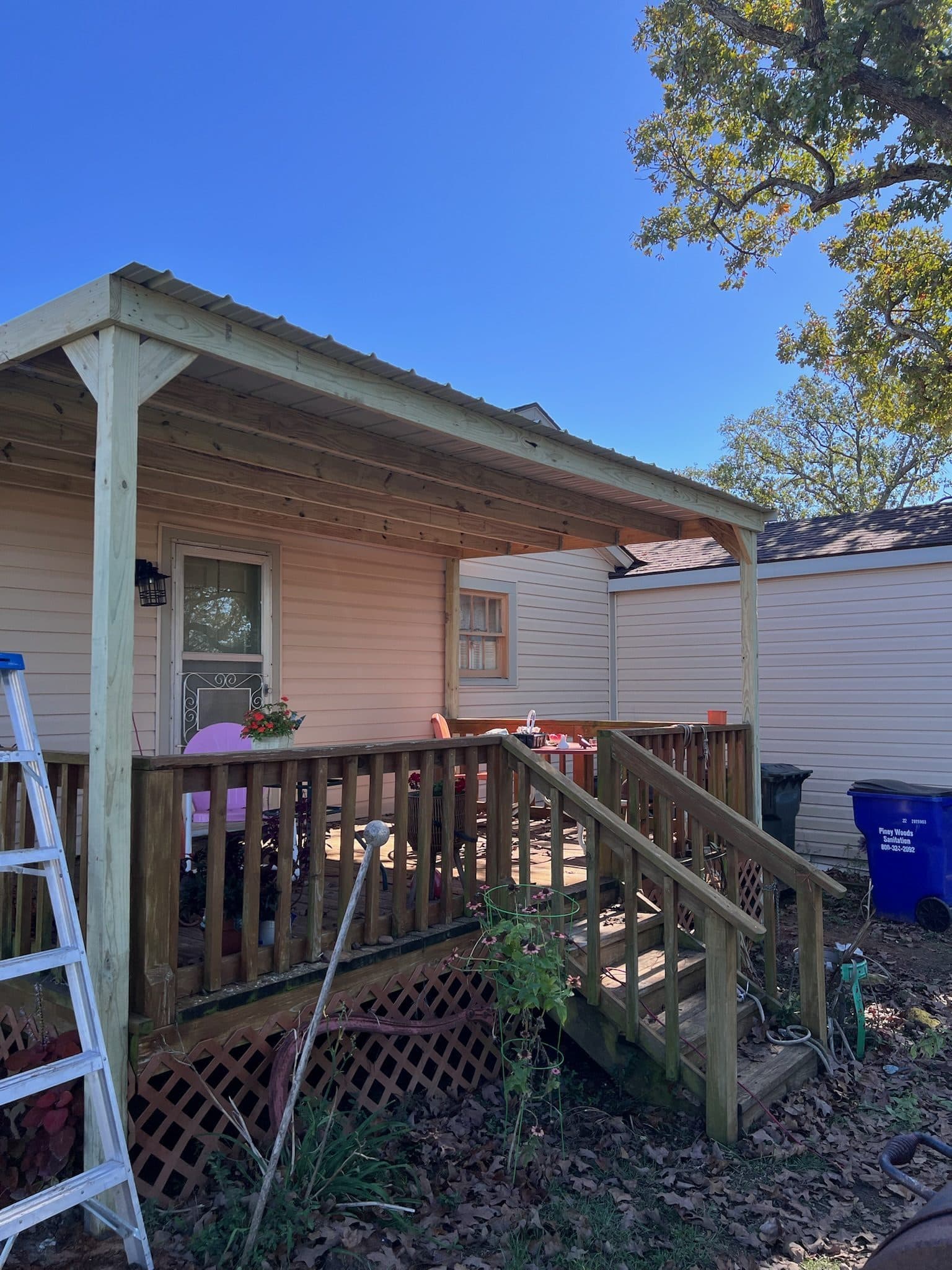New covered back porch with wood posts and corrugated metal roof