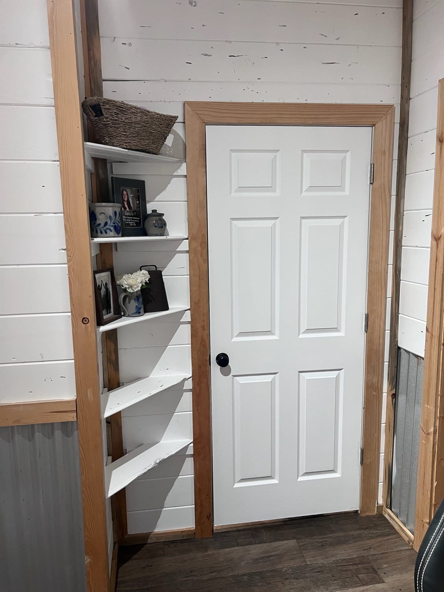 Tiny home corner shelving with shiplap walls and pine trim