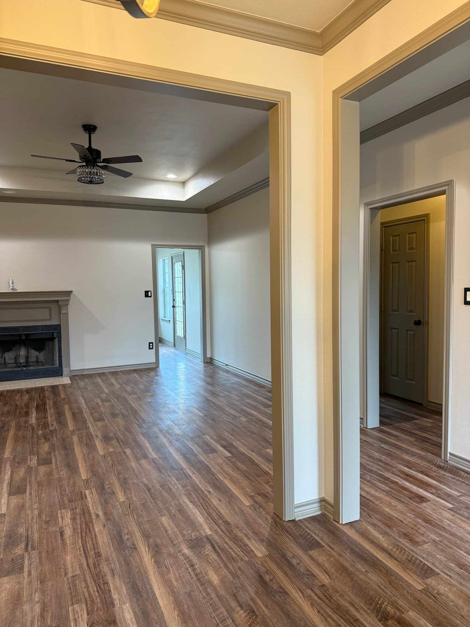 Refreshed living room with wood-burning fireplace and new LVT floor
